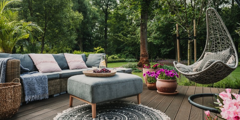 garden-patio-decorated-with-scandinavian-wicker-sofa-and-coffee-table-picture-id1208657520